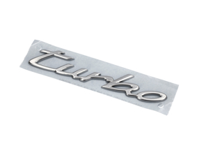 'Turbo' rear lid badge, light silver metallic. Porsche Taycan - 9J1853675COU2, 9J1853675C